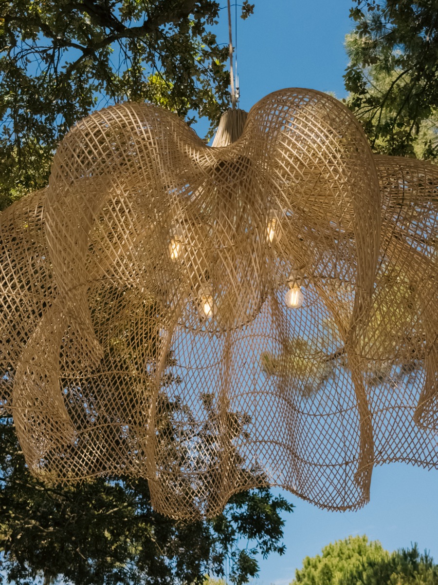 Lustre en osier tressé suspendu dans les arbres
